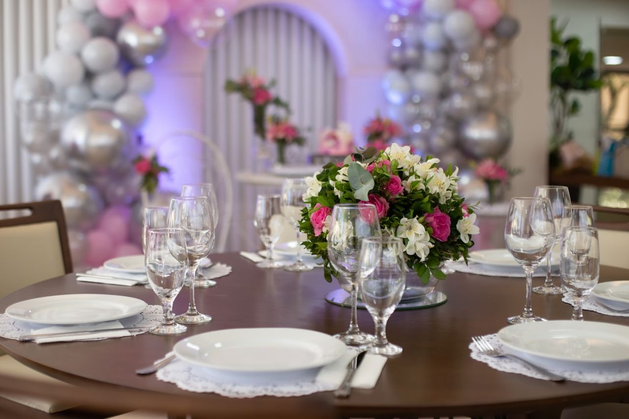 gallery-3 Elegant table setting with floral centerpiece at an indoor event, featuring glassware and plates.